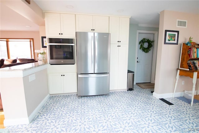 kitchen featuring visible vents, baseboards, white cabinetry, appliances with stainless steel finishes, and light floors