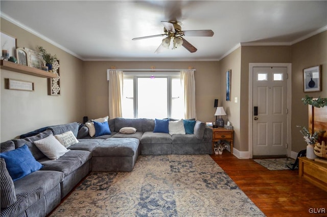 living room with dark wood-style floors, crown molding, baseboards, and ceiling fan