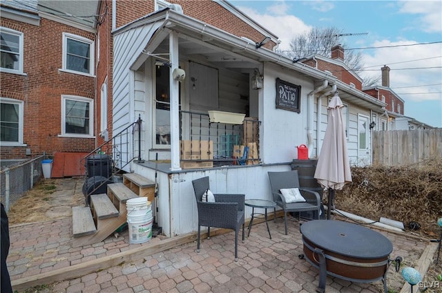 view of patio with entry steps and fence