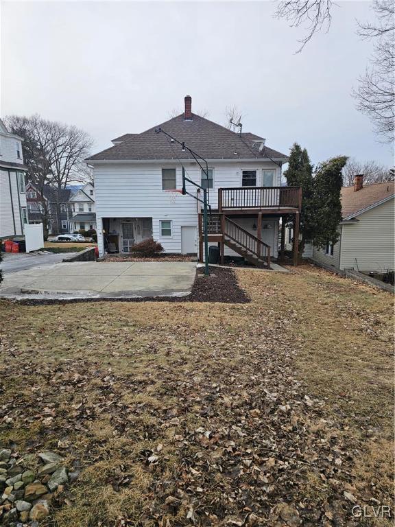 back of property featuring stairs and a wooden deck