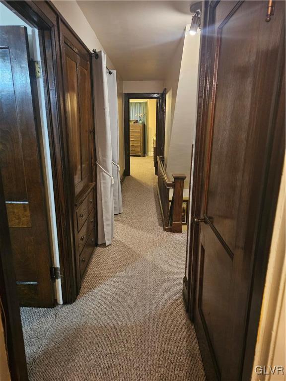 hallway with light colored carpet