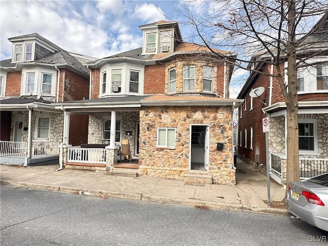 american foursquare style home featuring a porch