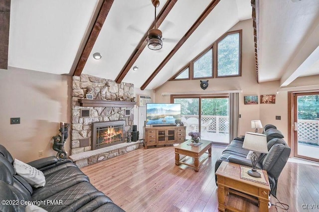 134 Moseywood Rd, Kidder Township S, PA 18624 - living area featuring high vaulted ceiling, beamed ceiling, a ceiling fan, a stone fireplace, and hardwood / wood-style floors
