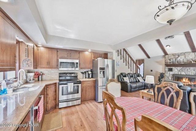 134 Moseywood Rd, Kidder Township S, PA 18624 - kitchen featuring open floor plan, lofted ceiling with beams, stainless steel appliances, backsplash, and a sink