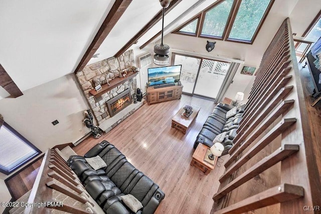 134 Moseywood Rd, Kidder Township S, PA 18624 - living room with a high ceiling, beamed ceiling, visible vents, a stone fireplace, and wood finished floors