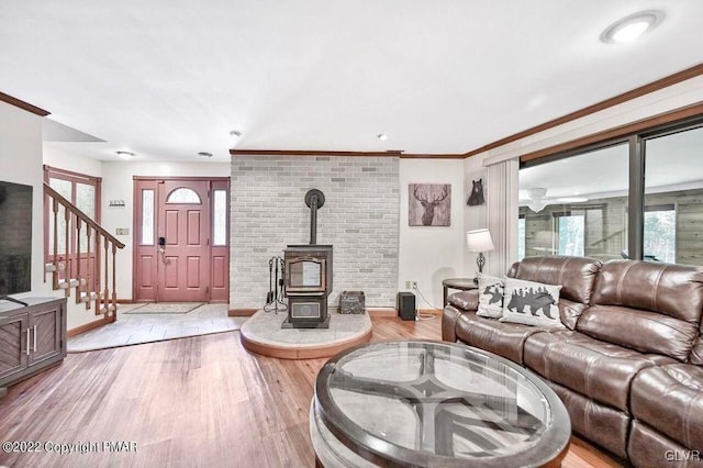 134 Moseywood Rd, Kidder Township S, PA 18624 - living room with baseboards, stairs, ornamental molding, wood finished floors, and a wood stove