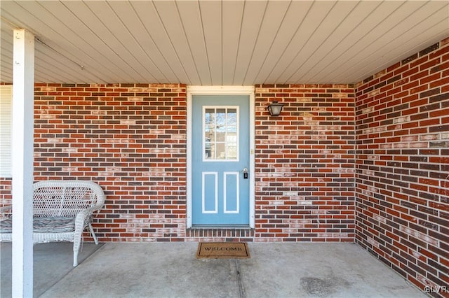 entrance to property with brick siding