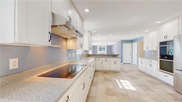 kitchen with stainless steel appliances, recessed lighting, white cabinets, and under cabinet range hood