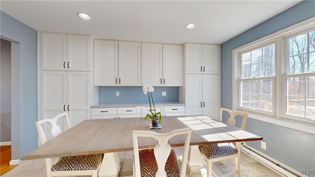 dining area with baseboards, a baseboard heating unit, and recessed lighting