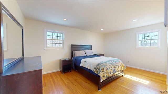 bedroom featuring light wood-type flooring, baseboards, and recessed lighting