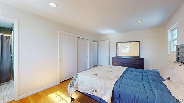 bedroom featuring baseboards, wood finished floors, and recessed lighting