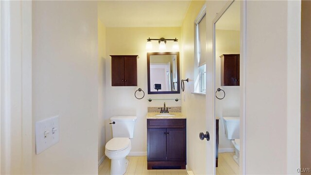 bathroom featuring toilet and vanity