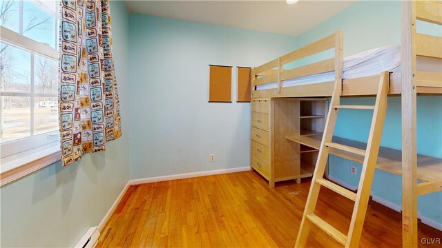 unfurnished bedroom featuring baseboards and light wood finished floors