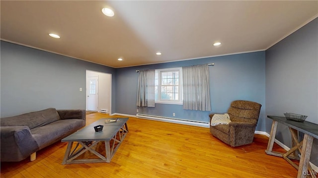 living area with recessed lighting, baseboard heating, ornamental molding, wood finished floors, and baseboards