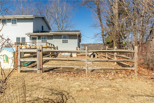 back of house with a gate and fence