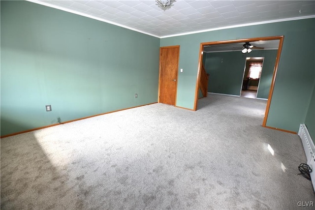 carpeted empty room featuring ornamental molding and baseboards