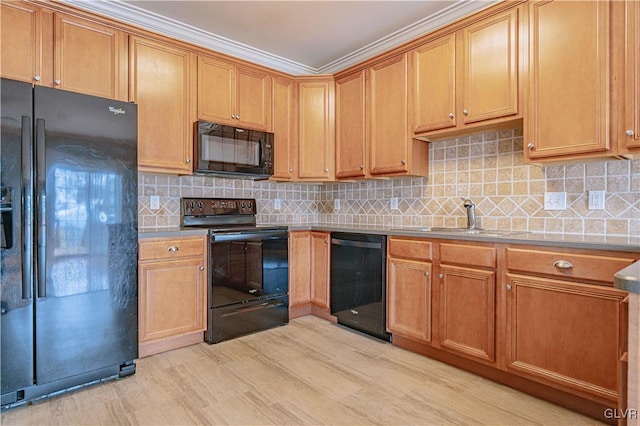 kitchen featuring a sink, light countertops, light wood-type flooring, backsplash, and black appliances