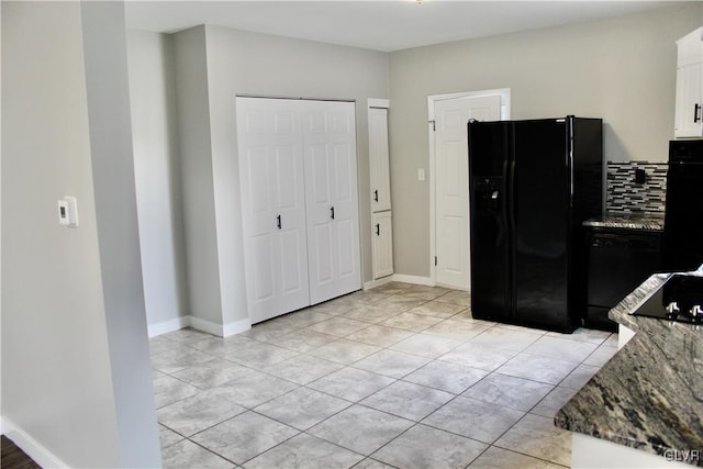 kitchen with black appliances, stone countertops, baseboards, and white cabinets