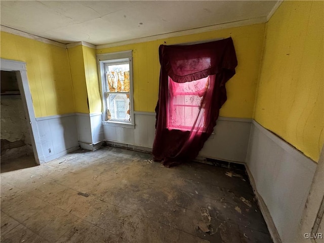 interior space with a wainscoted wall