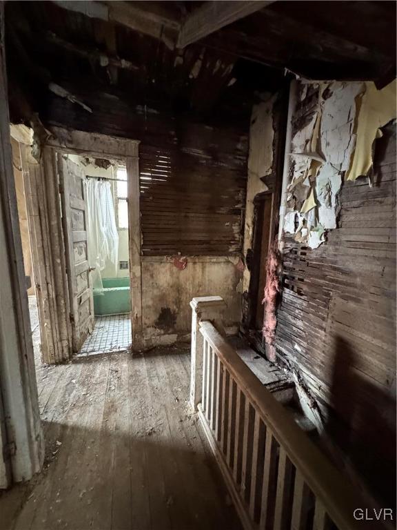 hallway with hardwood / wood-style flooring