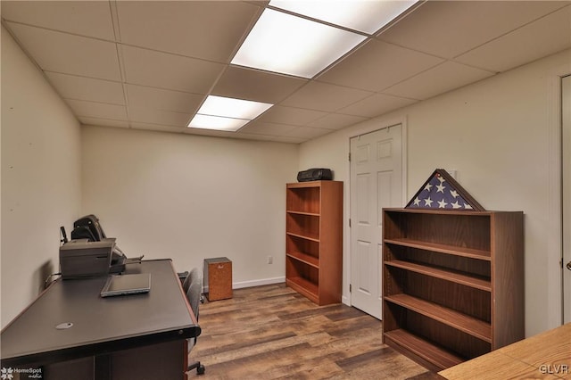 office area with a drop ceiling and wood finished floors