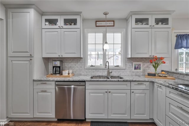 kitchen with white cabinetry, dishwasher, and a sink