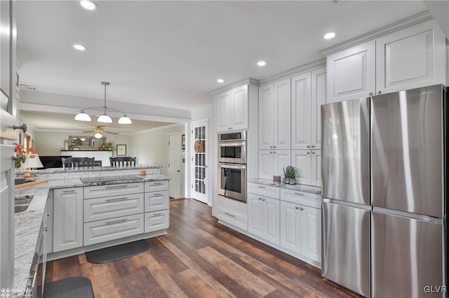 kitchen with dark wood-type flooring, a peninsula, light stone countertops, stainless steel appliances, and white cabinetry