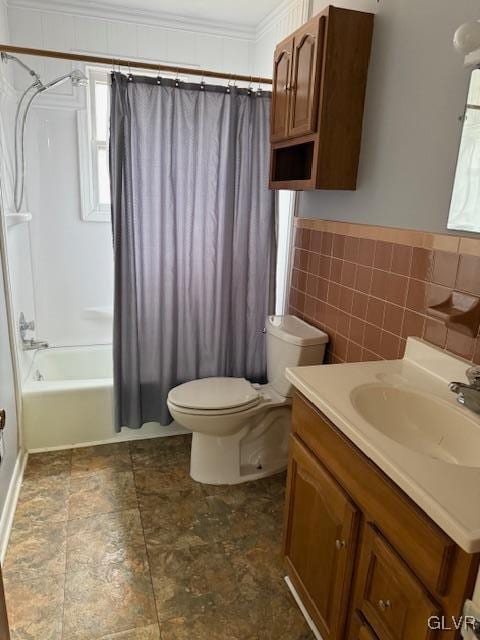 bathroom with toilet, shower / tub combo, vanity, tile walls, and ornamental molding