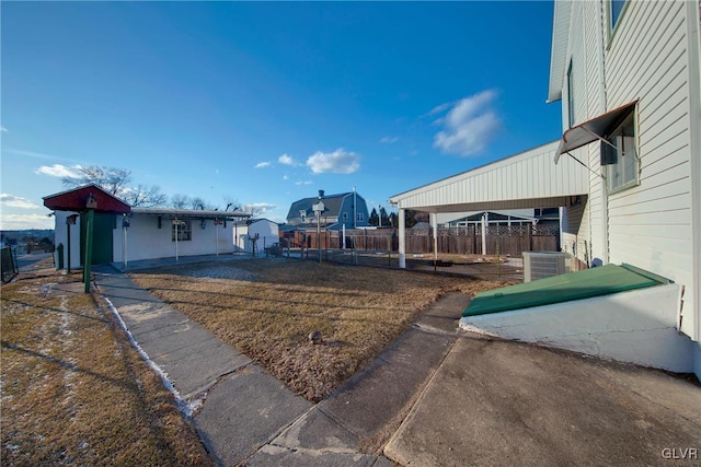 view of yard with fence and central air condition unit