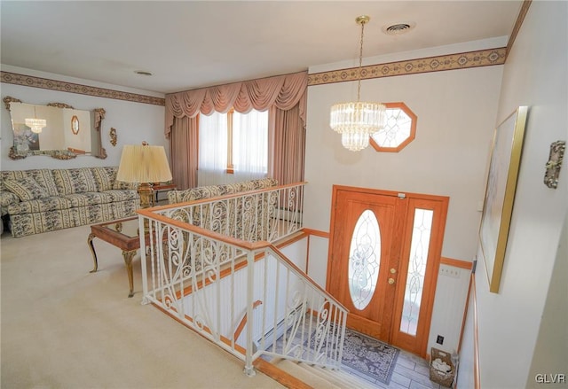 entryway featuring visible vents and a notable chandelier