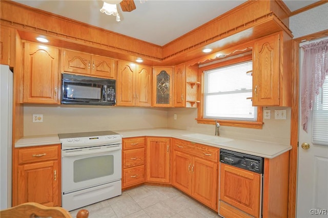 kitchen featuring black microwave, a sink, light countertops, white range with electric stovetop, and paneled dishwasher