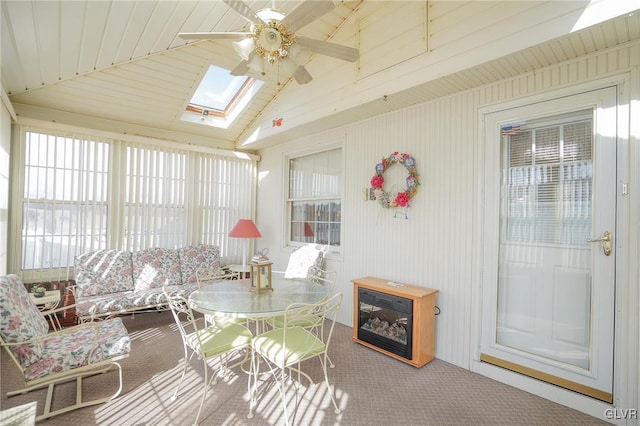 sunroom / solarium featuring ceiling fan and lofted ceiling with skylight