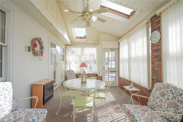 sunroom with lofted ceiling with skylight and ceiling fan