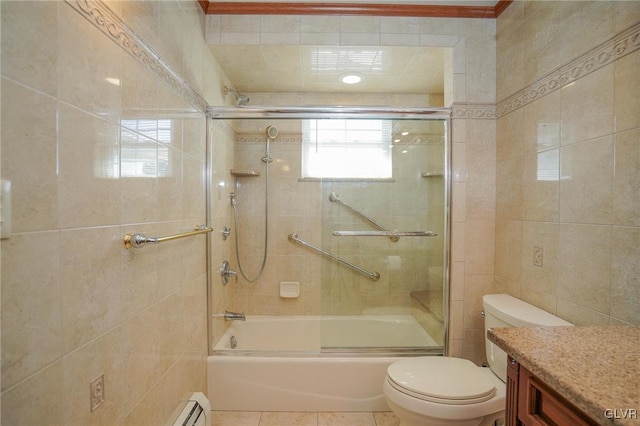 bathroom featuring shower / bath combination with glass door, tile walls, toilet, vanity, and tile patterned flooring