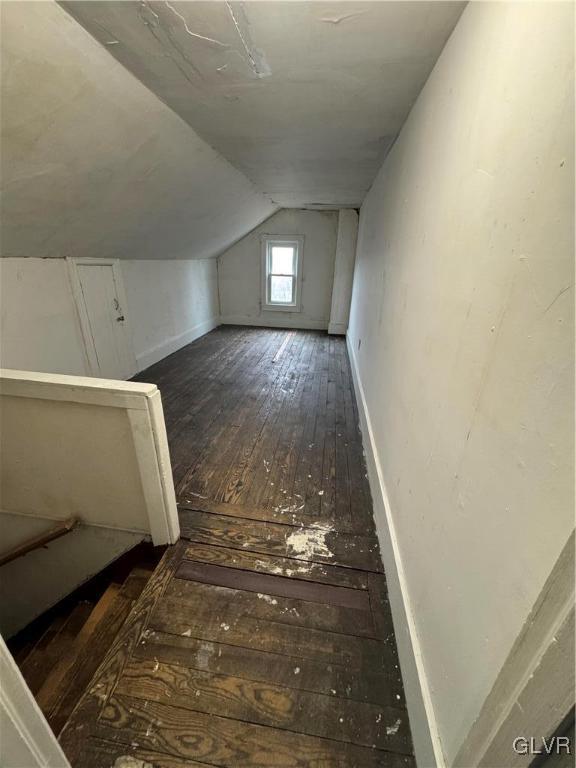 bonus room featuring vaulted ceiling, wood-type flooring, and baseboards