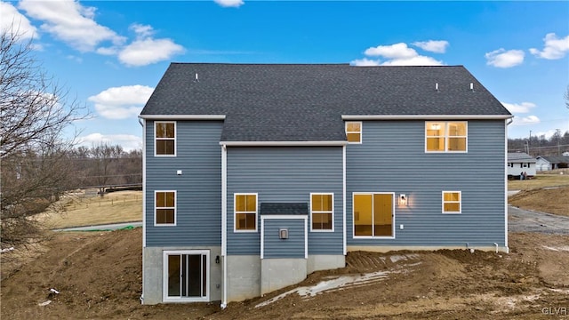 back of property featuring roof with shingles