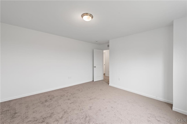 unfurnished room with carpet floors and baseboards