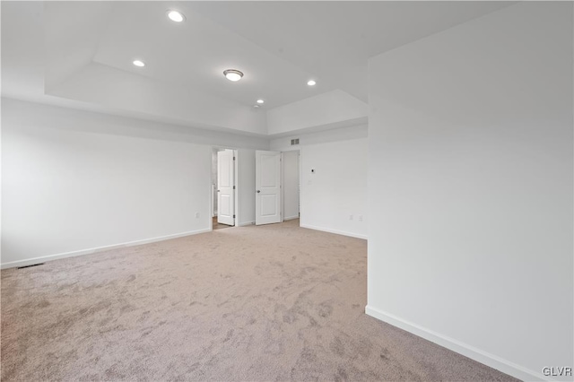 spare room featuring carpet floors, visible vents, baseboards, and recessed lighting