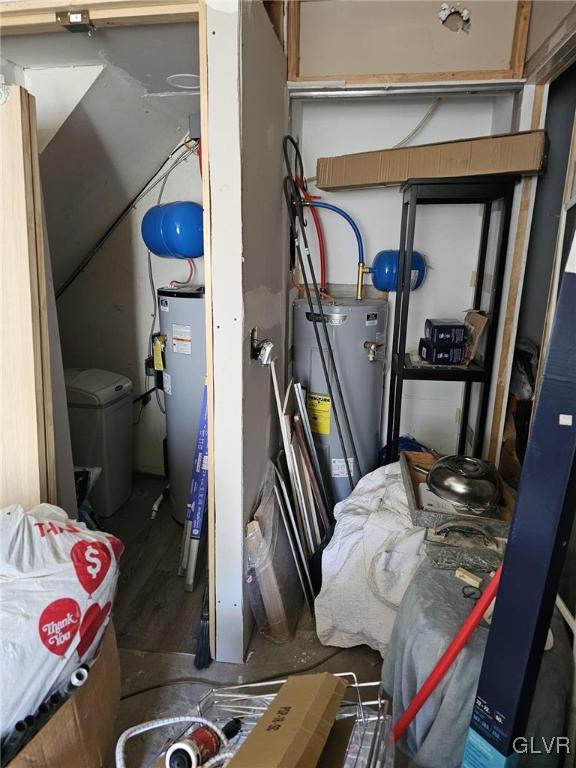 utility room with water heater and electric water heater