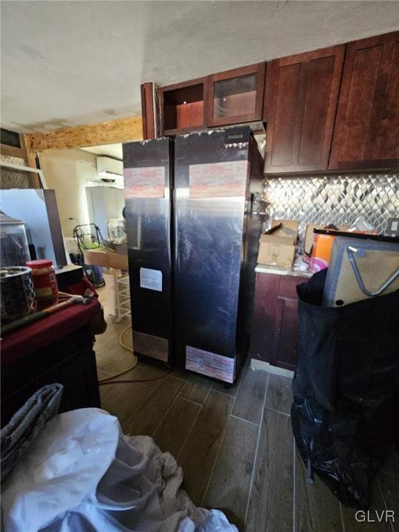 kitchen featuring wood tiled floor, tasteful backsplash, and freestanding refrigerator