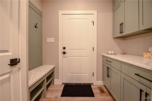 mudroom with light wood-style floors, visible vents, and baseboards