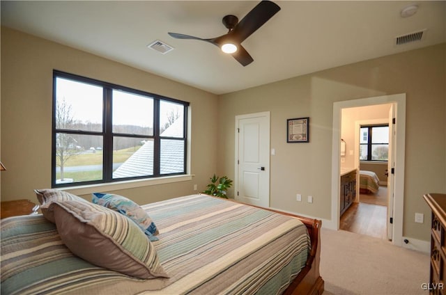 carpeted bedroom with baseboards, visible vents, and a ceiling fan