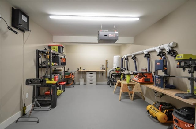 garage with baseboards, a workshop area, and a garage door opener