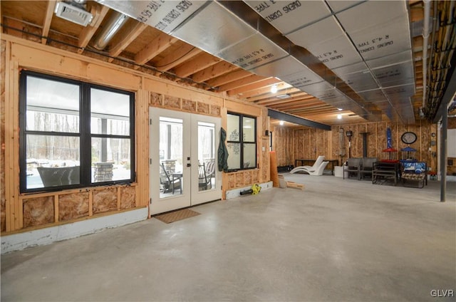 basement featuring french doors and visible vents