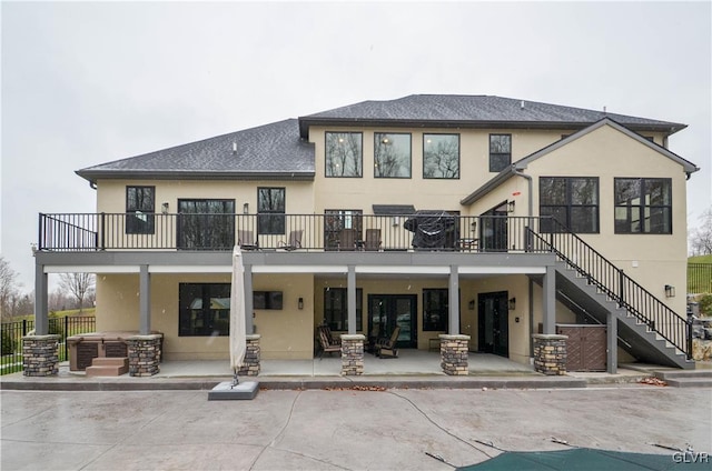 rear view of property with stairs, a patio, fence, and stucco siding