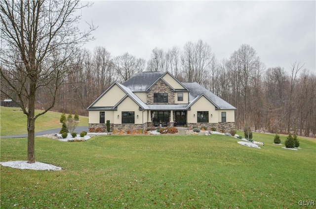 view of front of property with stone siding, a front lawn, and stucco siding