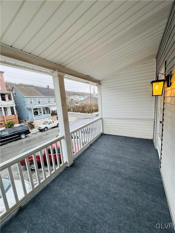 balcony with a residential view and covered porch