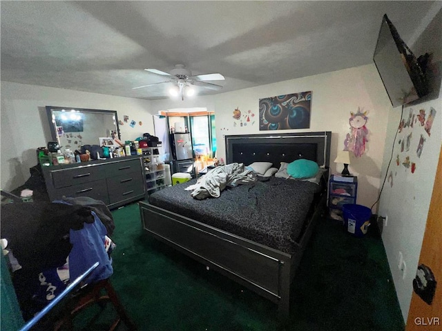 bedroom featuring ceiling fan and dark carpet