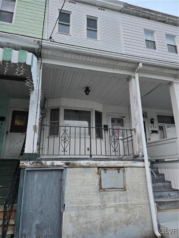 view of side of property featuring covered porch