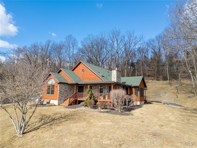 rustic home featuring a front yard, roof with shingles, and a chimney